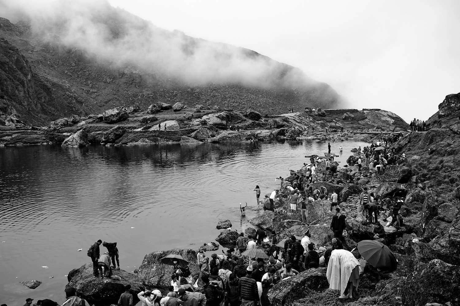Devotees performing rituals including taking a dip in in the lake