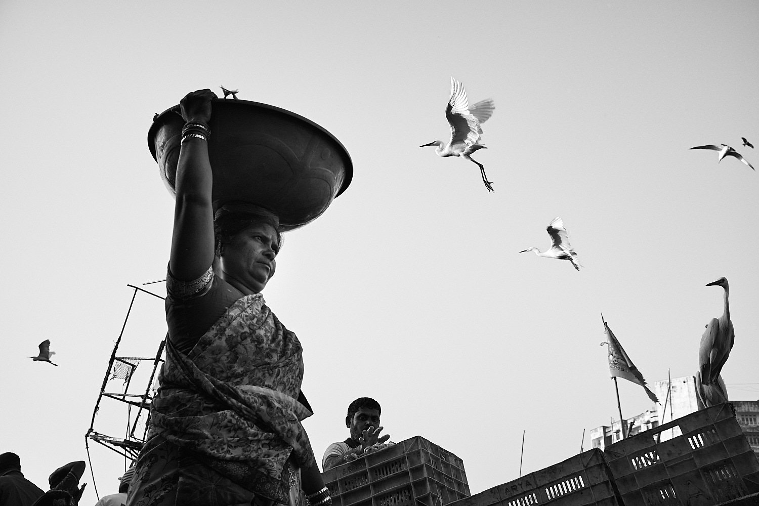 February 2023, Mumbai, India: A woman at Sassoon Docks leaving with fish