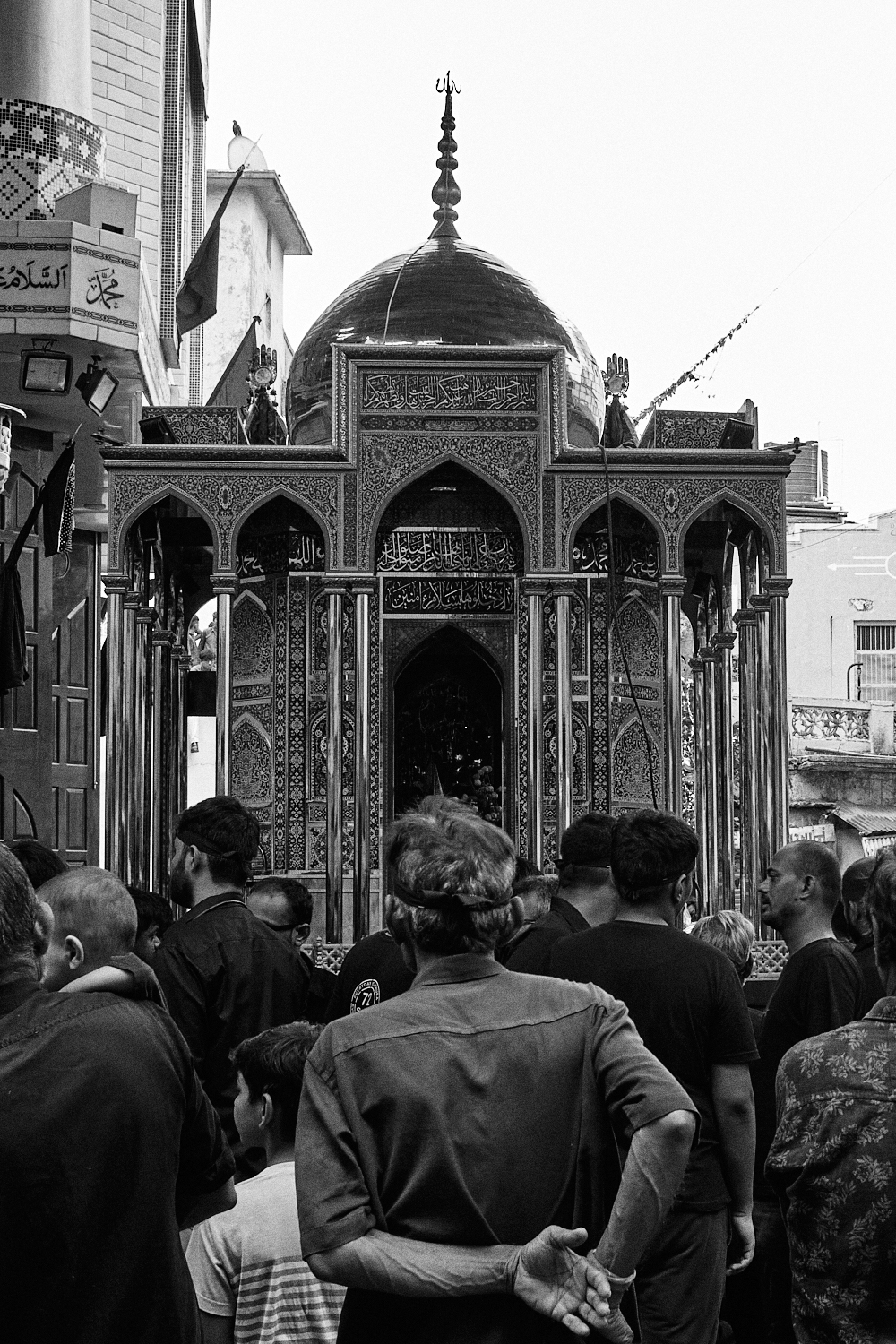 People gather around a tazia. Ahmedabad, India. 2023