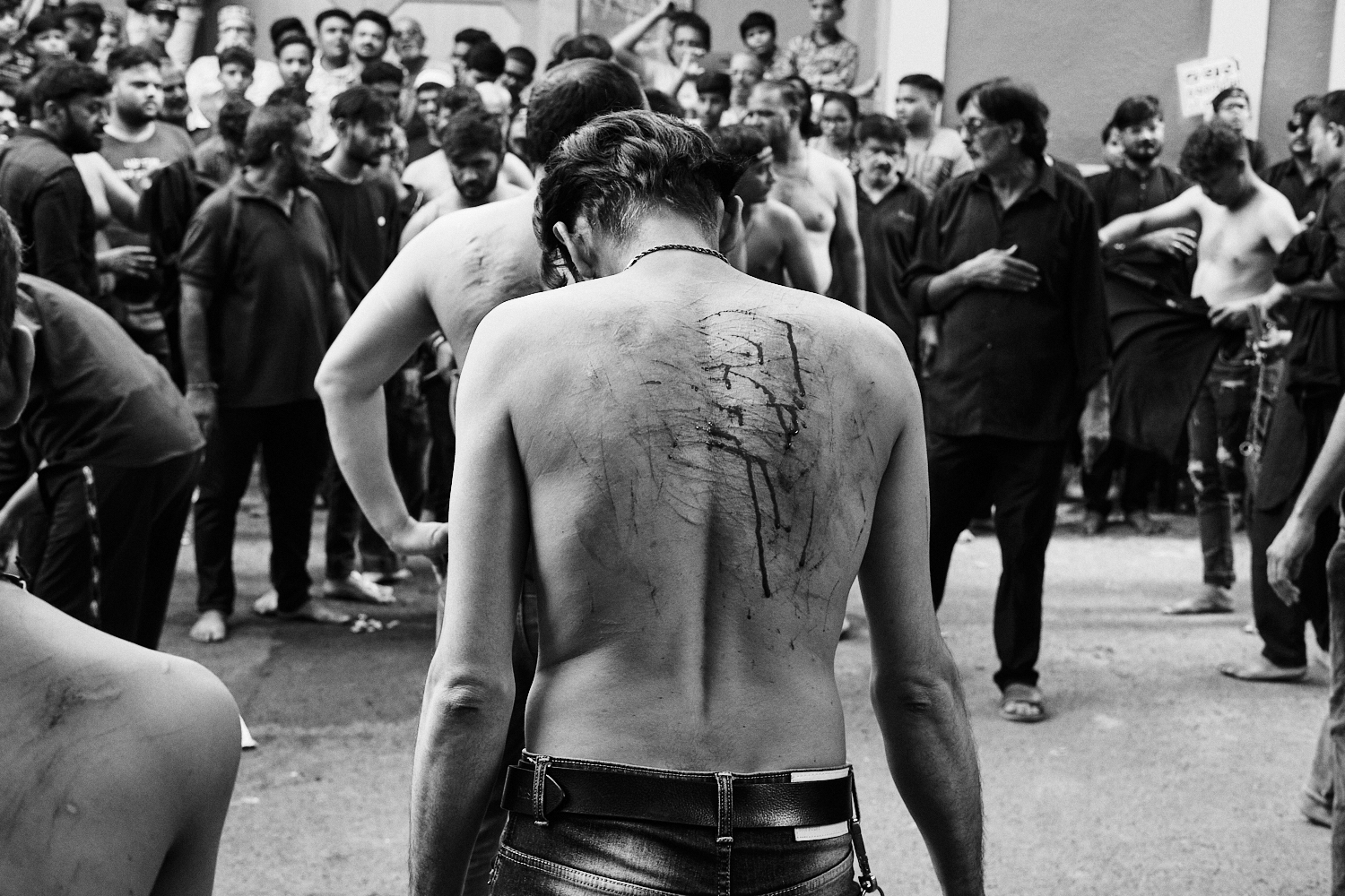 Bleeding back of a man after self-flagellation. Ahmedabad, India. 2023.