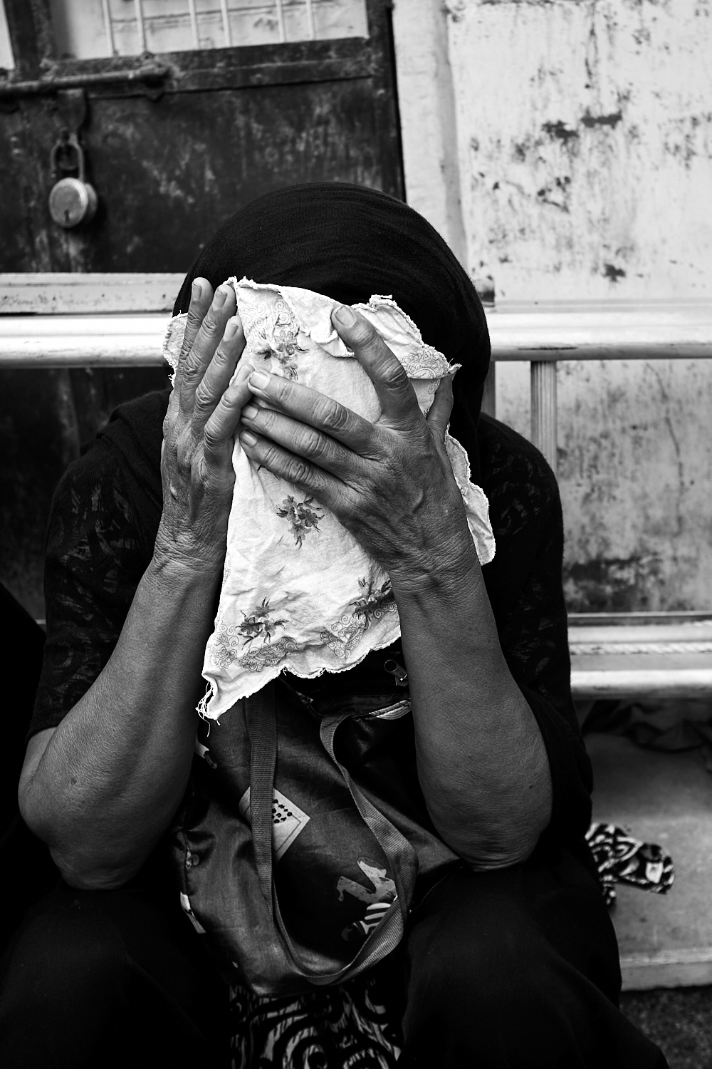 An elderly woman mourns during the observance of Ashura/Muharram. Ahmedabad, India. 2024
