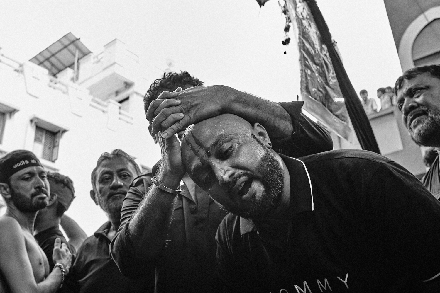 A man reacts after receiving a cut on his forehead during Ashura/Muharram observance. Ahmedabad, India. 2024