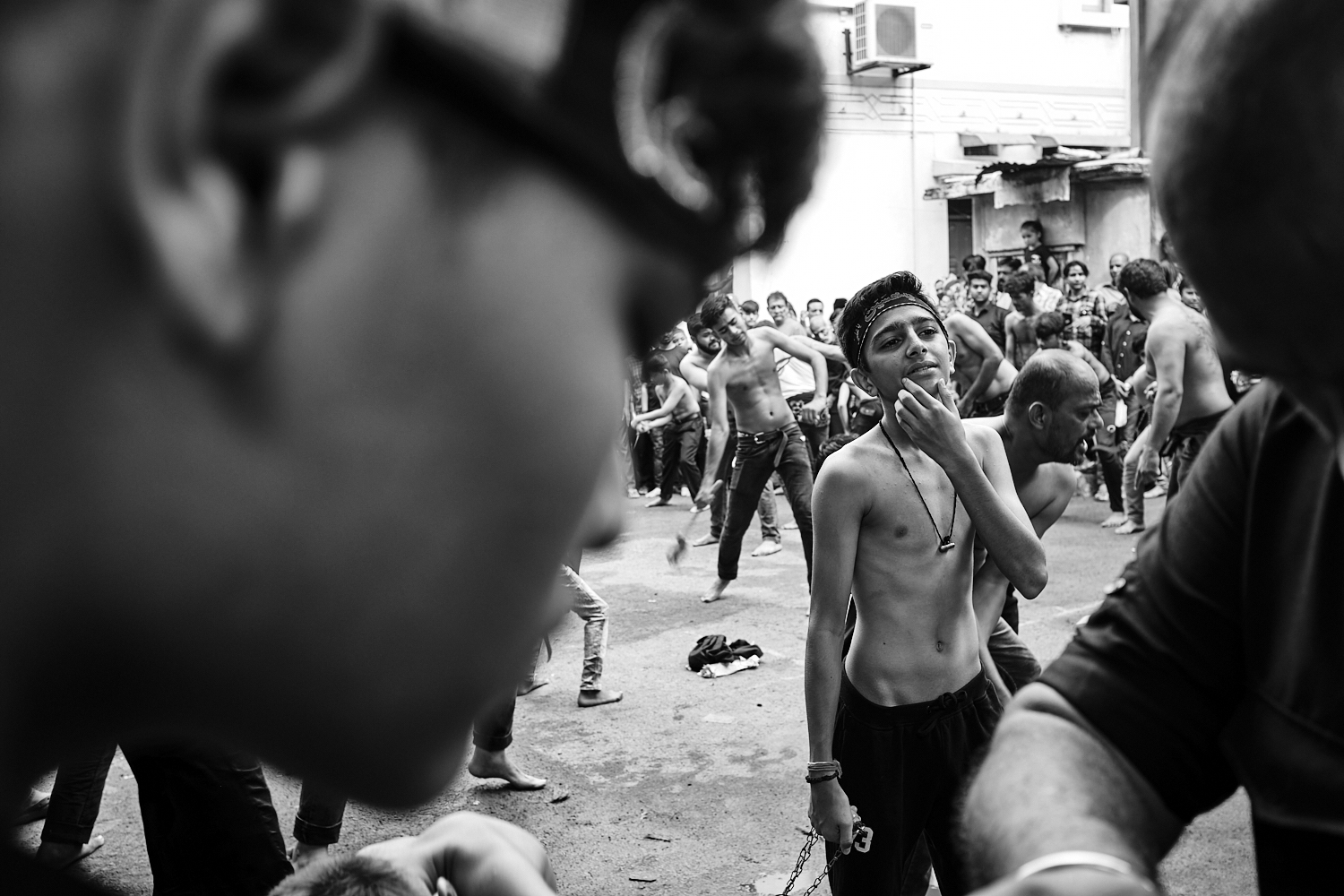 A young boy readies to perform tatbir during Ashura/Muharram observance. Ahmedabad, India. 2024.